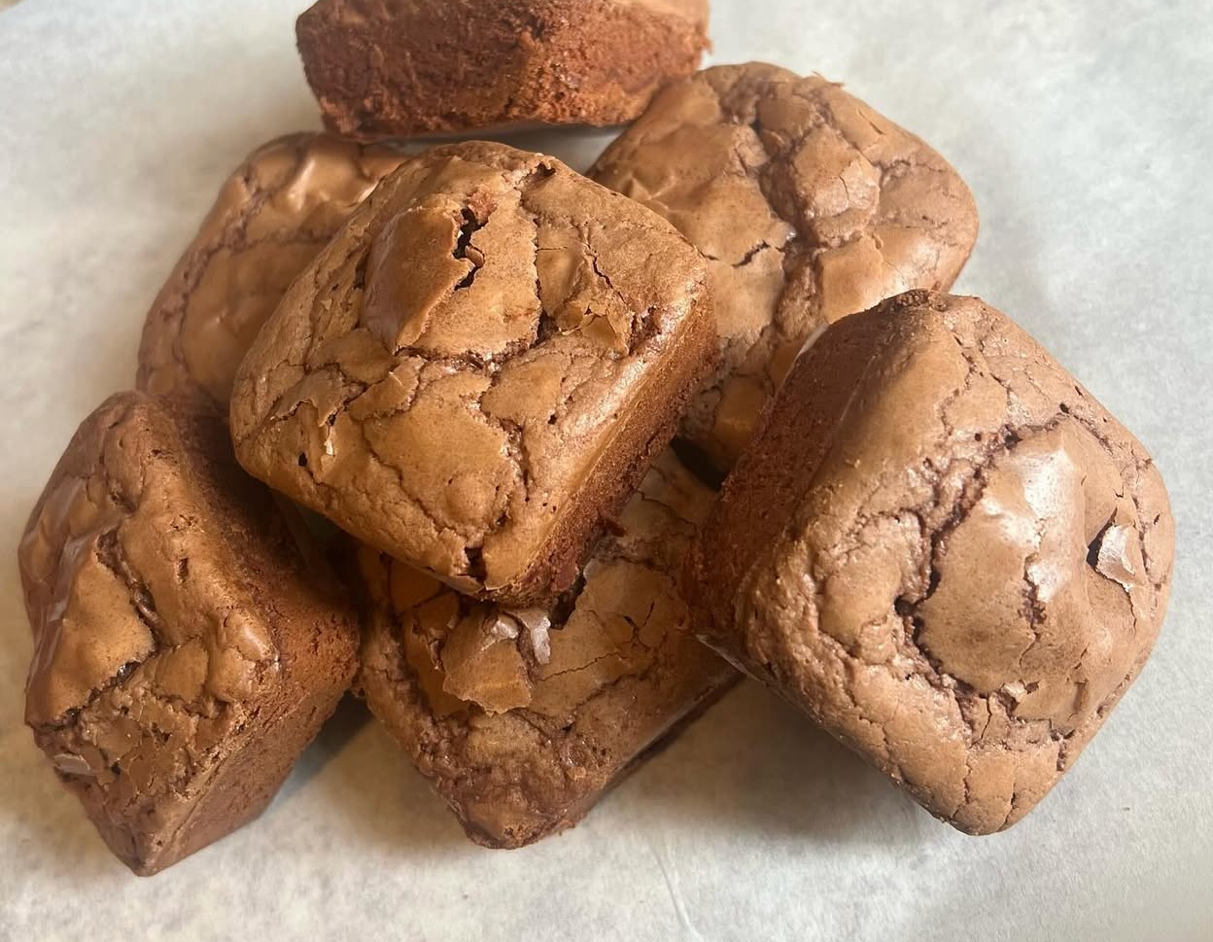 Toxic Snacks brownie bites — rich, fudgy, piled on parchment paper