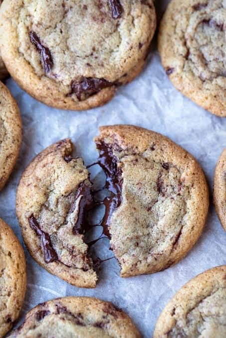 Toxic Snacks chocolate chip cookies — thick, gooey, broken open showing melted chocolate